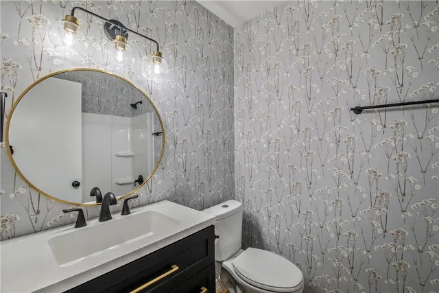 a bathroom with a sink a toilet and mirror