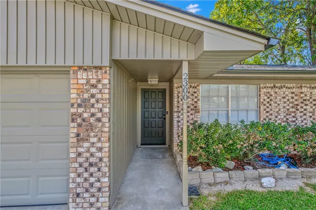 a view of a house with potted plants