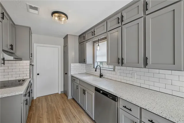 a kitchen with a sink and a refrigerator
