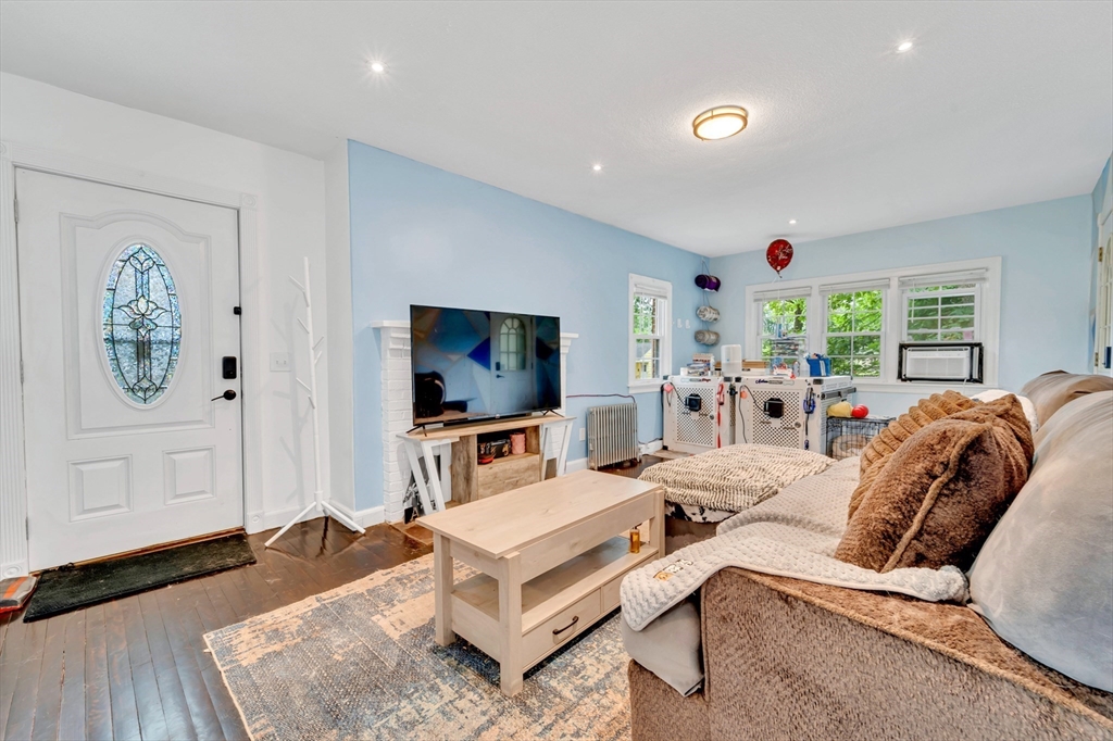 295 Harkness Avenue Springfield, MA 01118 - Photo 15 of 39 a living room with furniture a flat screen tv and a large window