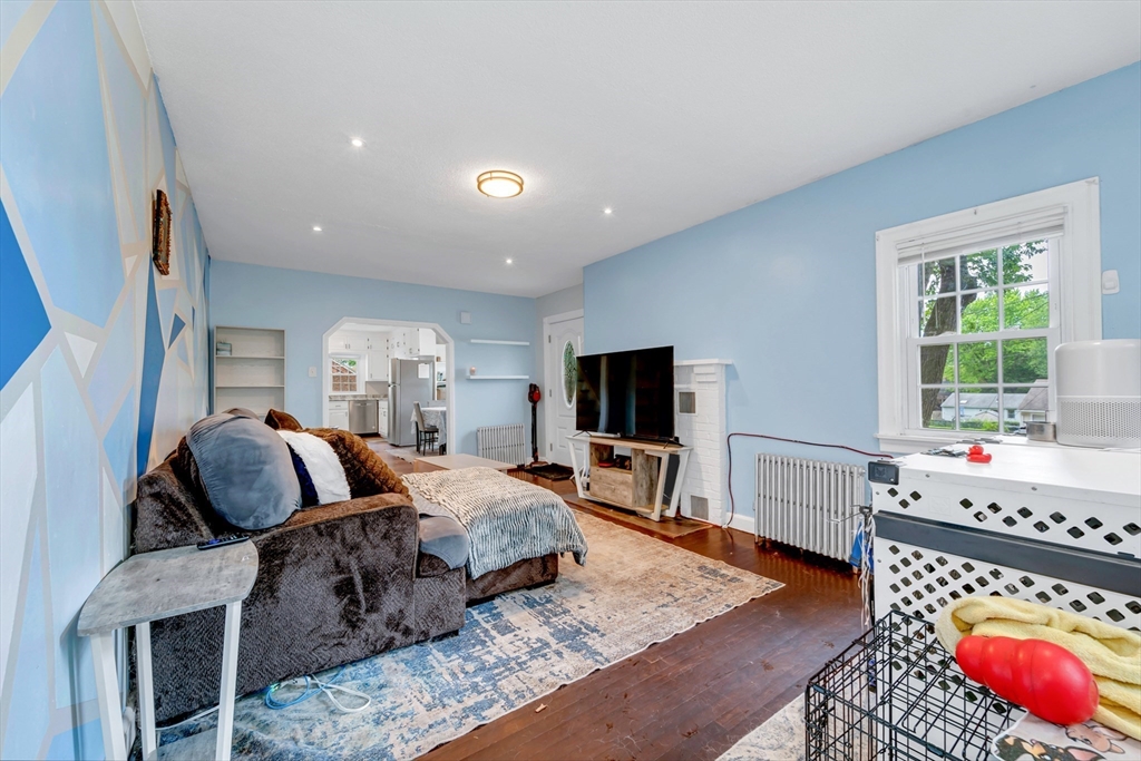 295 Harkness Avenue Springfield, MA 01118 - Photo 17 of 39 a living room with furniture a flat screen tv and a large window