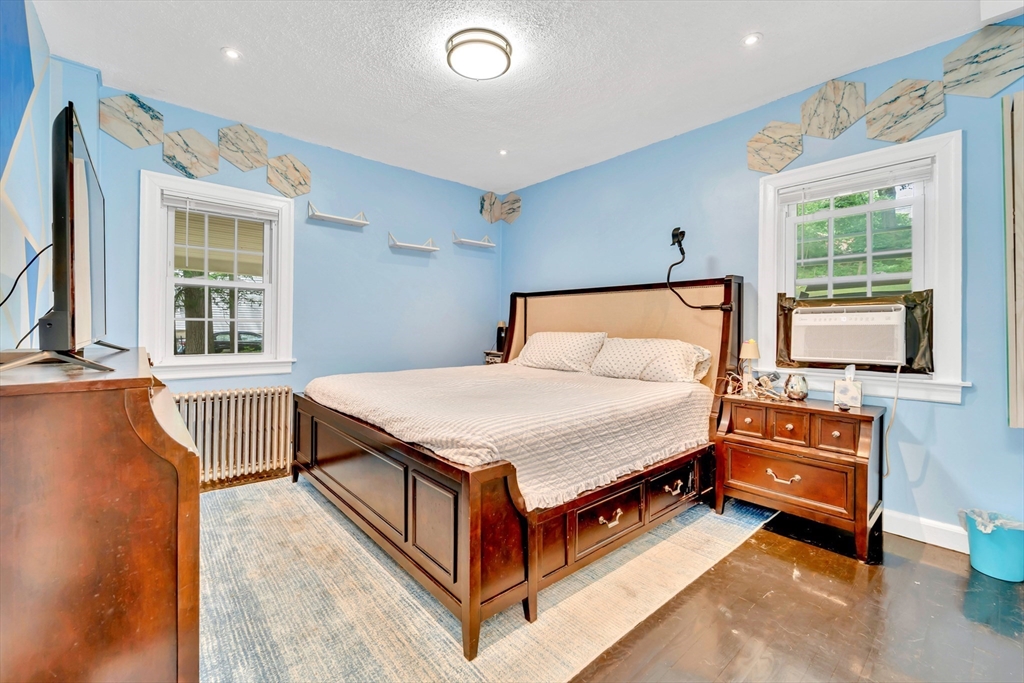 295 Harkness Avenue Springfield, MA 01118 - Photo 18 of 39 a spacious bedroom with a bed and wooden floor