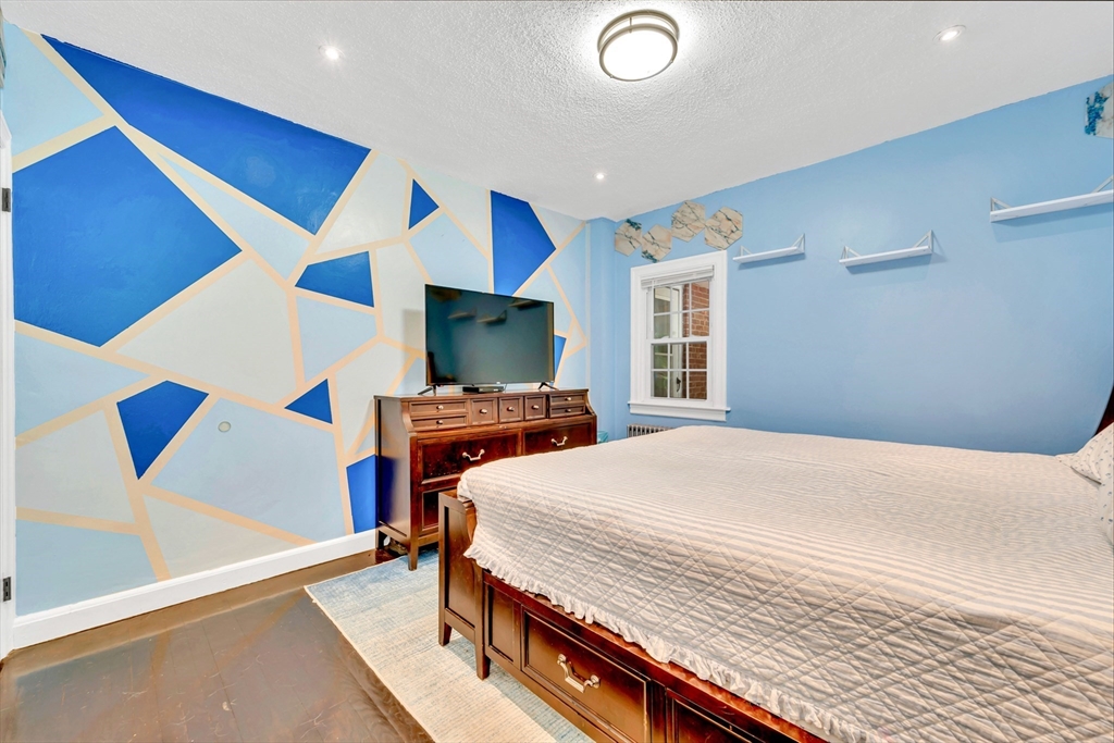 295 Harkness Avenue Springfield, MA 01118 - Photo 20 of 39 a bedroom with a bed and a flat screen tv