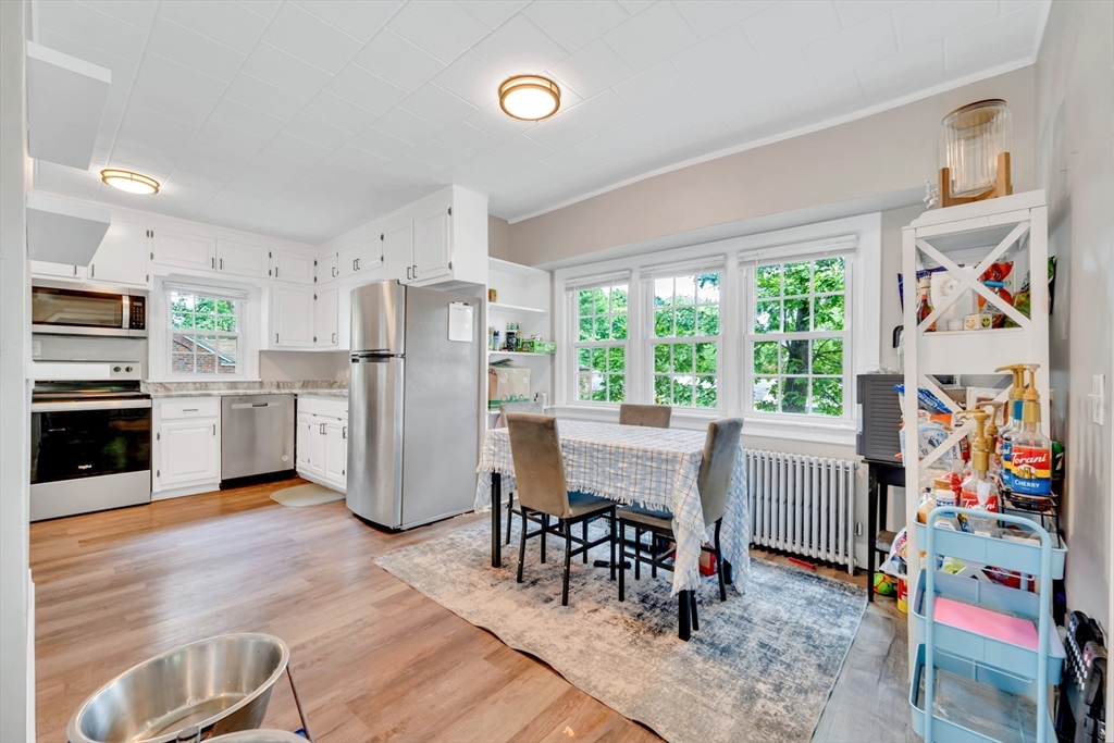 295 Harkness Avenue Springfield, MA 01118 - Photo 2 of 39 a kitchen with stainless steel appliances wooden floor and dining table