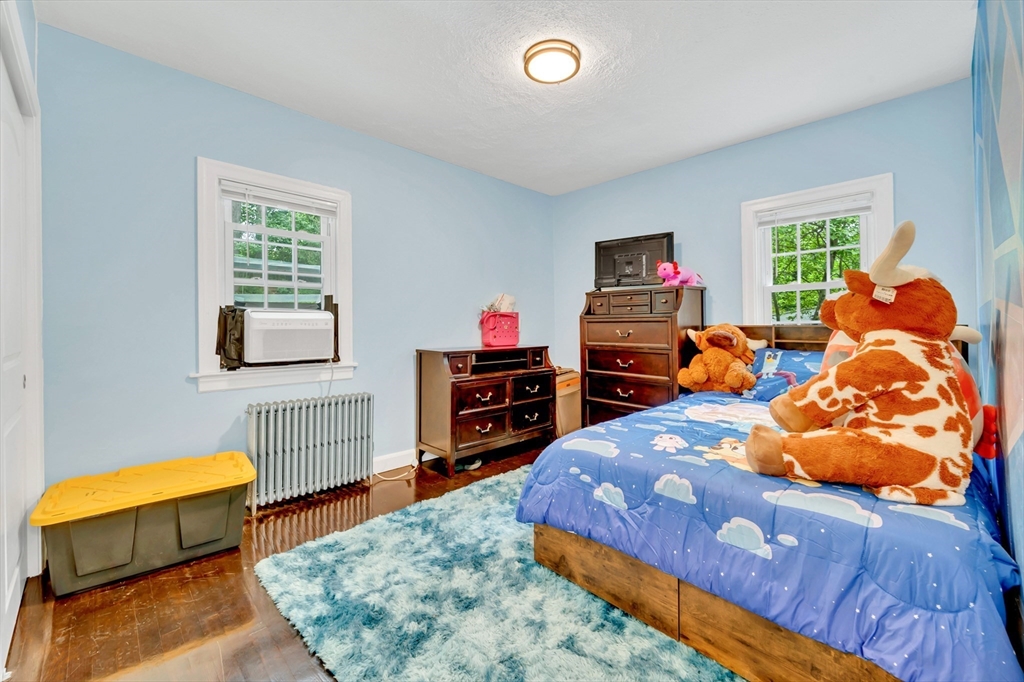 295 Harkness Avenue Springfield, MA 01118 - Photo 22 of 39 a bedroom with a bed and a tv in it