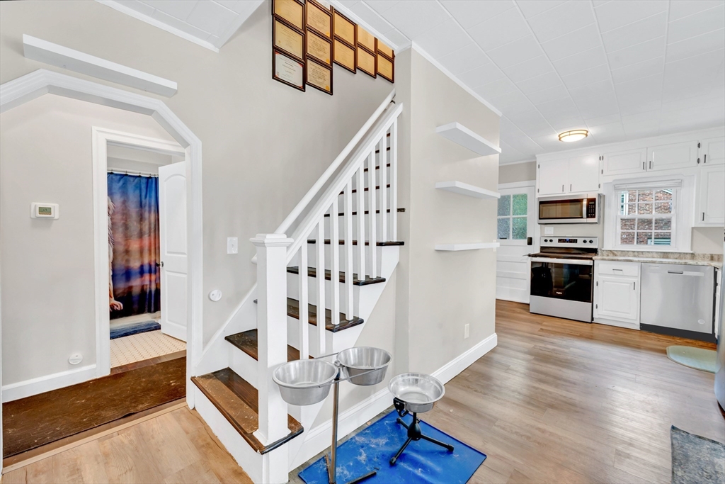 295 Harkness Avenue Springfield, MA 01118 - Photo 26 of 39 a living room with furniture and kitchen view with wooden floor