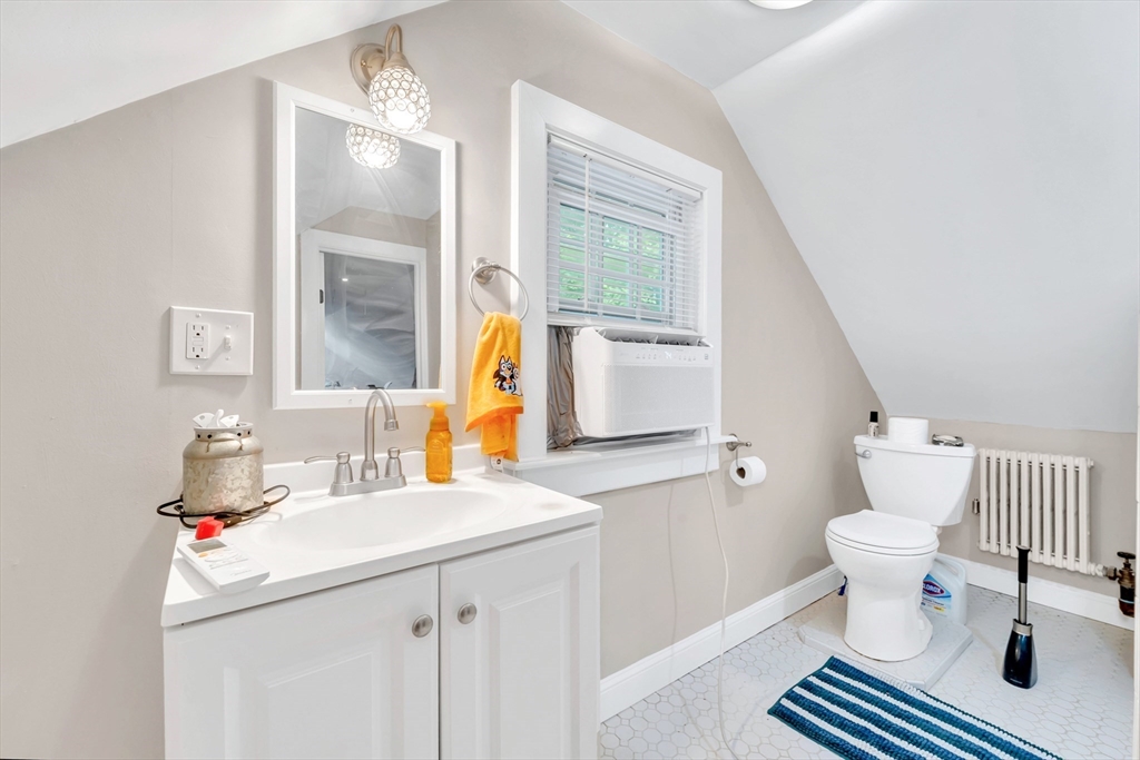 295 Harkness Avenue Springfield, MA 01118 - Photo 31 of 39 a bathroom with a sink toilet and a mirror