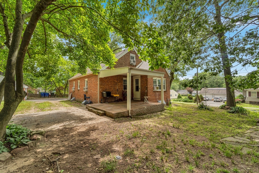 295 Harkness Avenue Springfield, MA 01118 - Photo 33 of 39 a view of a house with backyard and a tree