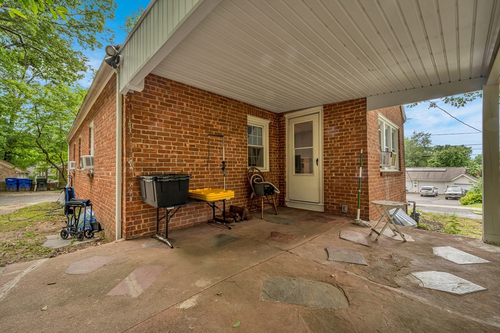 295 Harkness Avenue Springfield, MA 01118 - Photo 37 of 39 a view of a patio with table and chairs and a barbeque