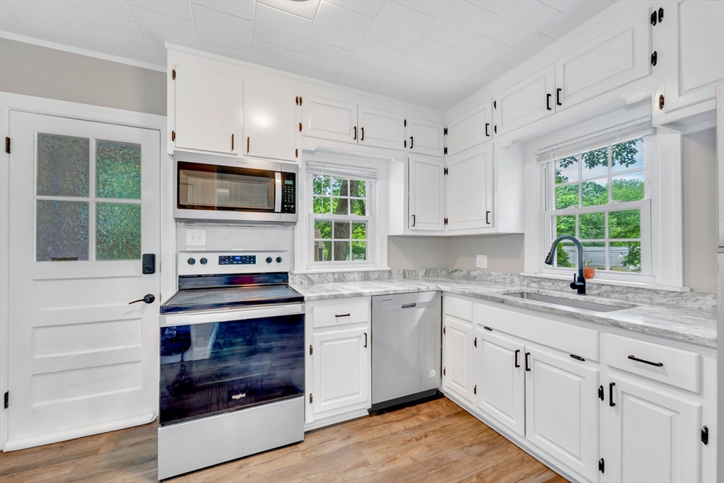 295 Harkness Avenue Springfield, MA 01118 - Photo 4 of 39 a kitchen with cabinets appliances a window and a sink