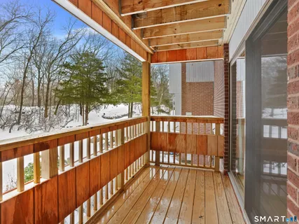 a view of balcony with wooden floor