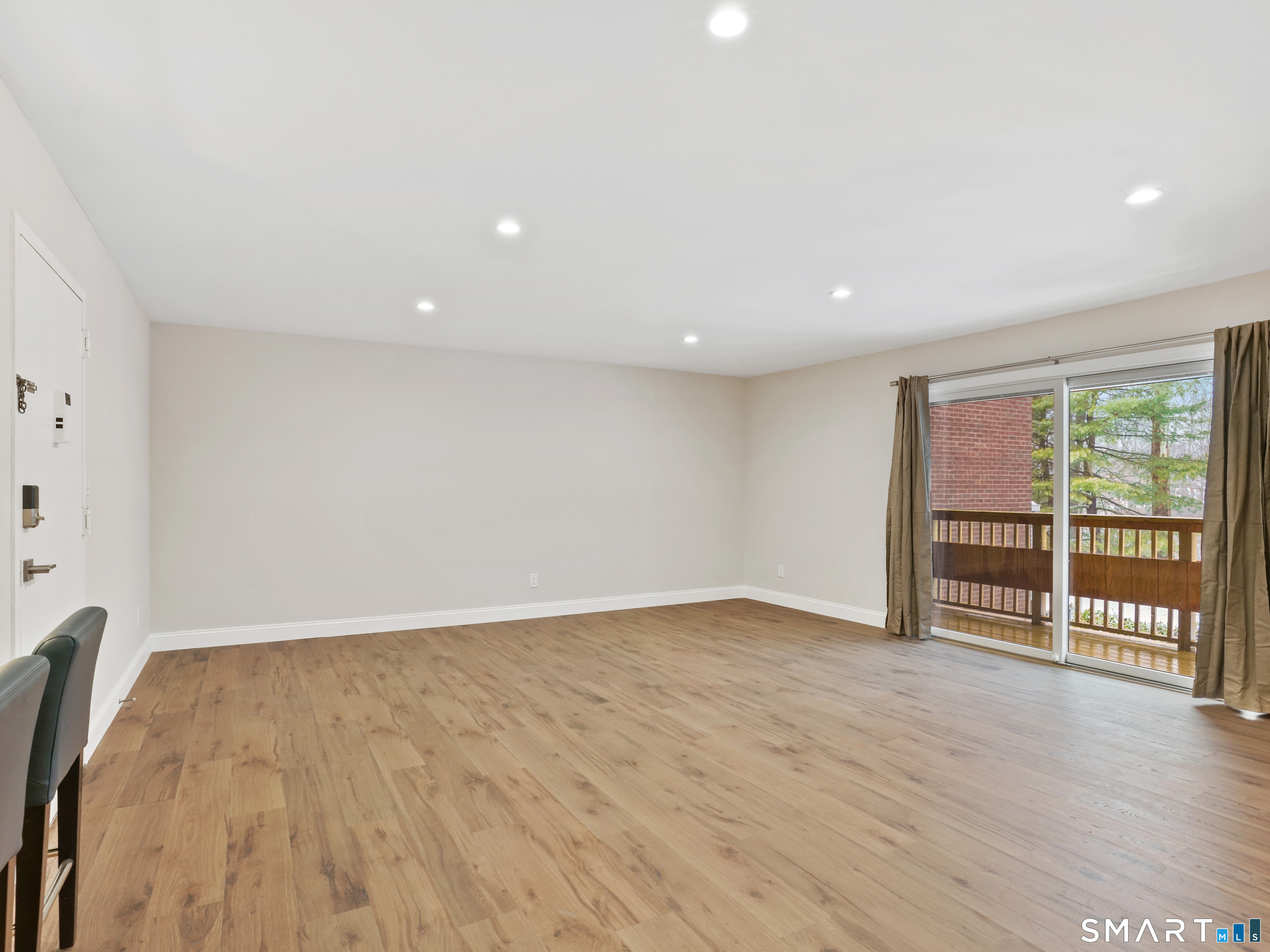 92 Wilton Crest Road Wilton, CT 06897 - Photo 3 of 19 wooden floor in an empty room with a window