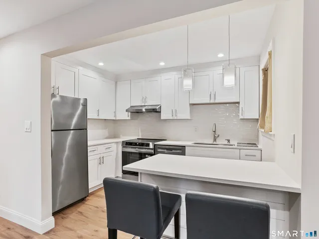 a kitchen with a refrigerator a sink and a stove