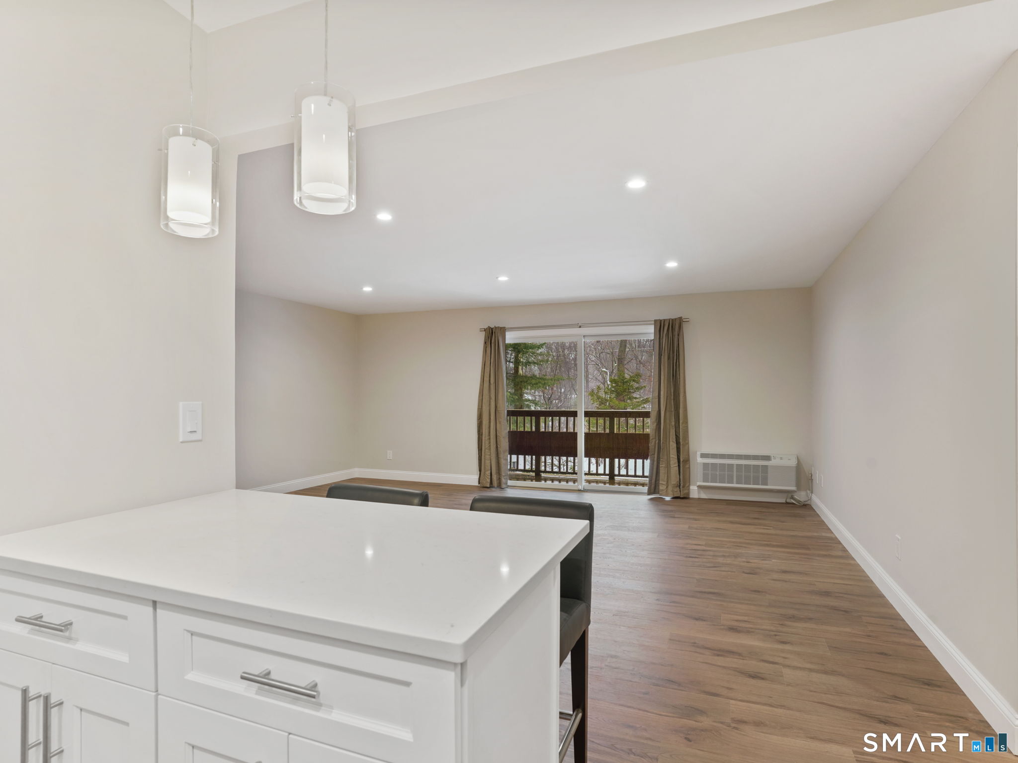 92 Wilton Crest Road Wilton, CT 06897 - Photo 6 of 19 a large white room with wooden floor