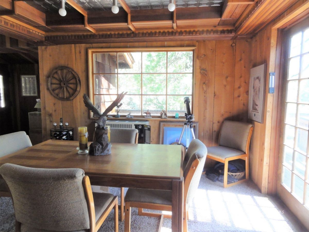 24945 Fern Valley Road Idyllwild, CA 92549 - Photo 11 of 28 a view of a dining room with furniture window and outside view
