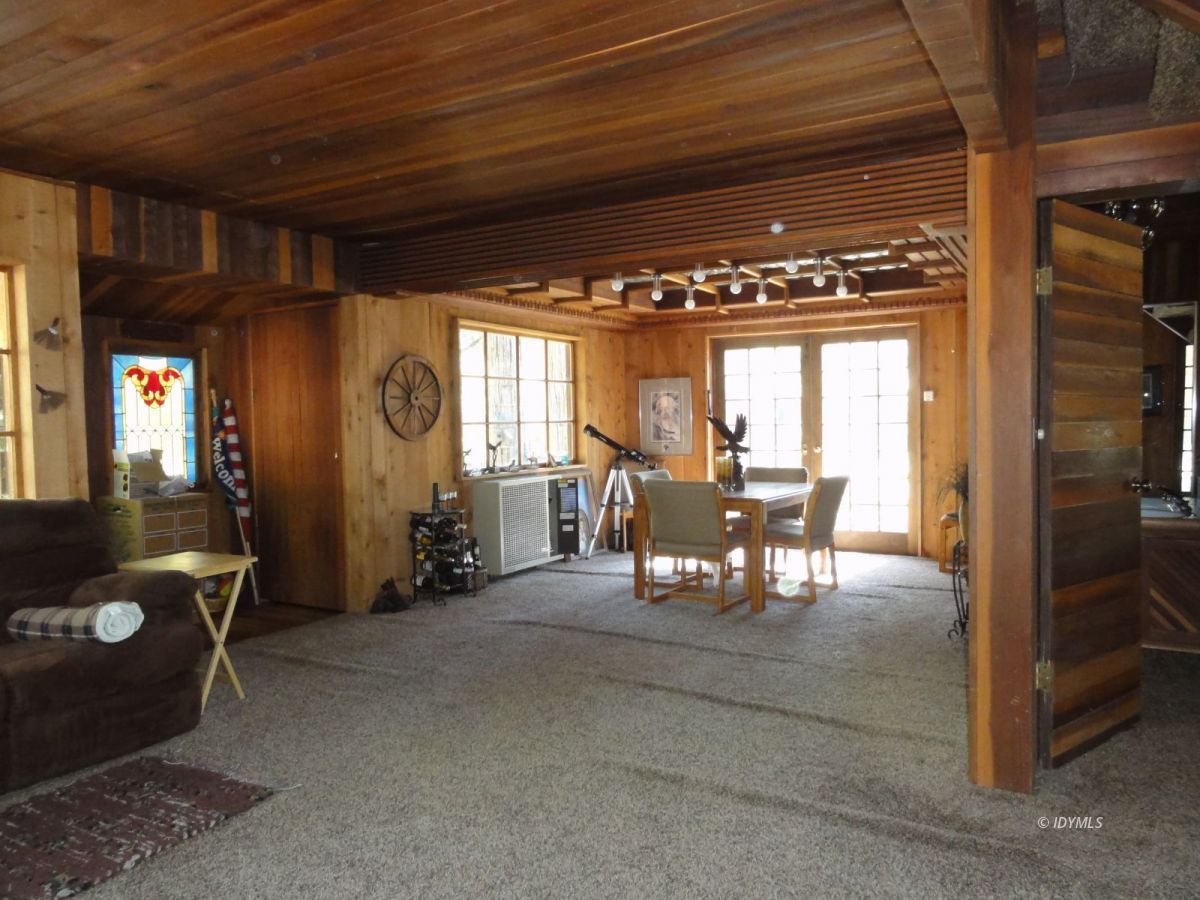 24945 Fern Valley Road Idyllwild, CA 92549 - Photo 23 of 28 a dining room with furniture and a floor to ceiling window