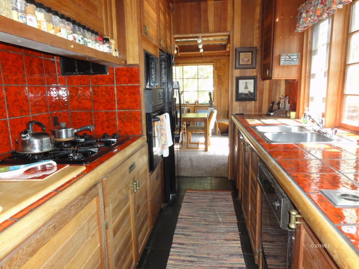24945 Fern Valley Road Idyllwild, CA 92549 - Photo 8 of 28 a kitchen with stainless steel appliances granite countertop a sink and wooden cabinets