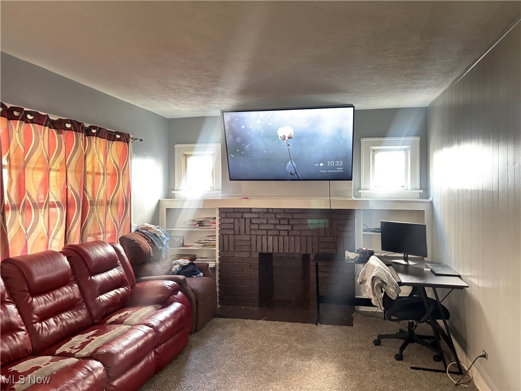 417 Arbor Road Cleveland, OH 44108 - Photo 15 of 20 Carpeted home theater featuring a brick fireplace and a textured ceiling