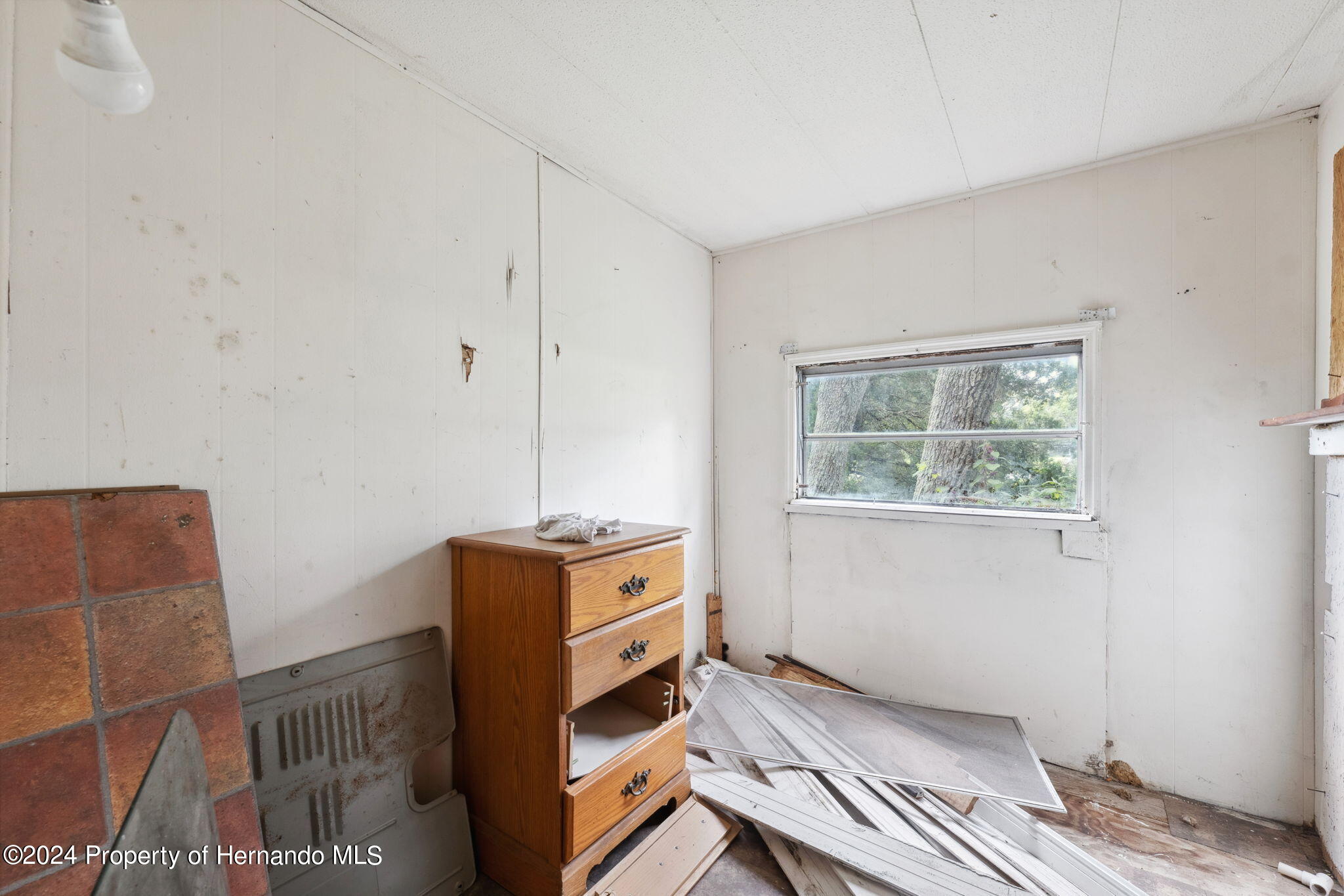 11017 Knuckey Road Weeki Wachee, FL 34614 - Photo 11 of 39 a living room with furniture and a window