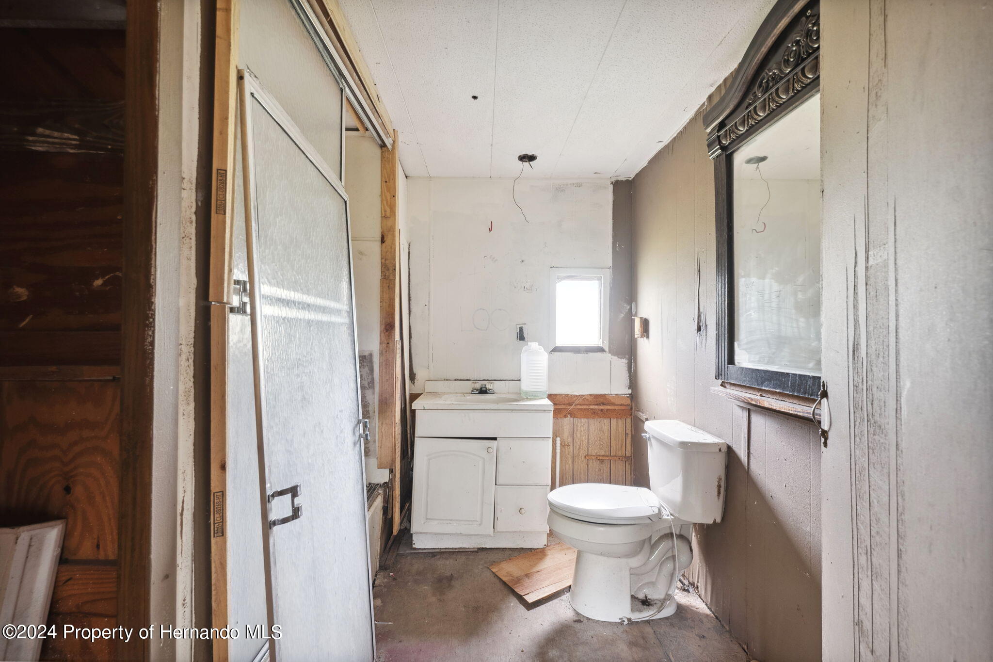 11017 Knuckey Road Weeki Wachee, FL 34614 - Photo 13 of 39 a bathroom with a toilet and a shower