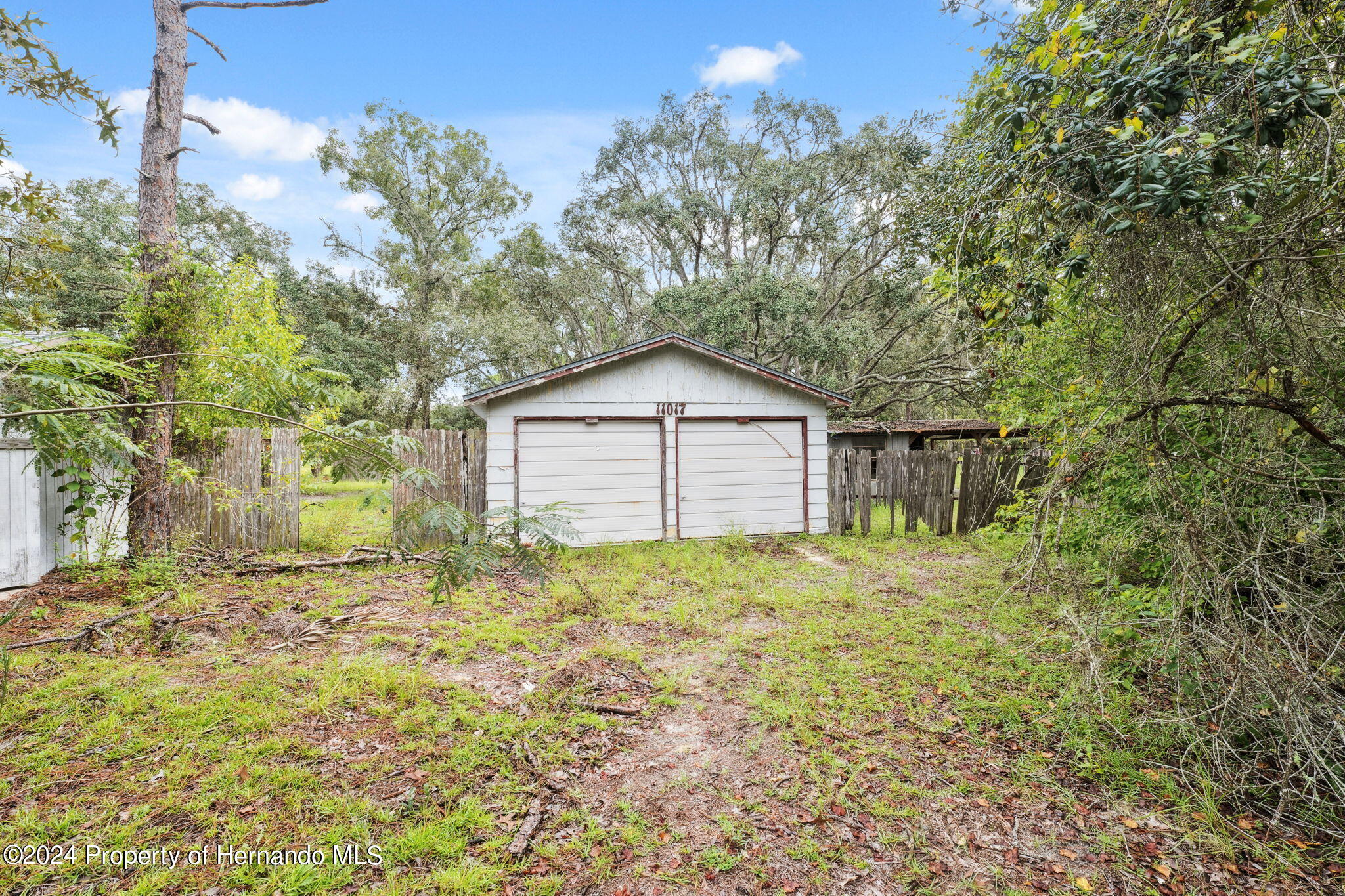 11017 Knuckey Road Weeki Wachee, FL 34614 - Photo 17 of 39 a yellow house with yard in front of it