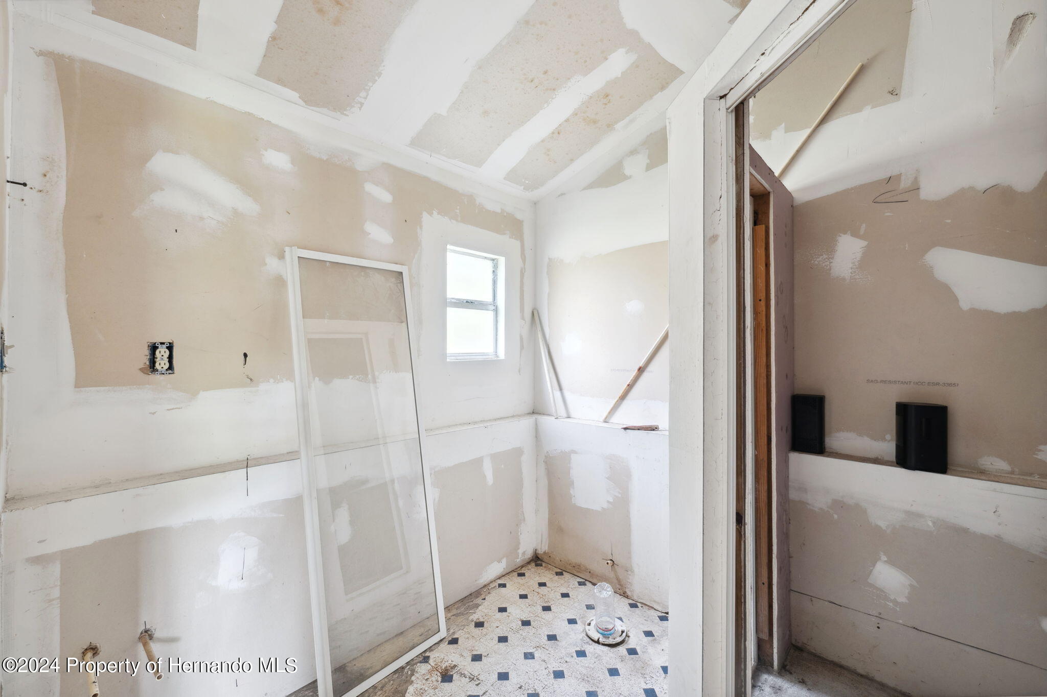 11017 Knuckey Road Weeki Wachee, FL 34614 - Photo 20 of 39 a bathroom with a glass door shower