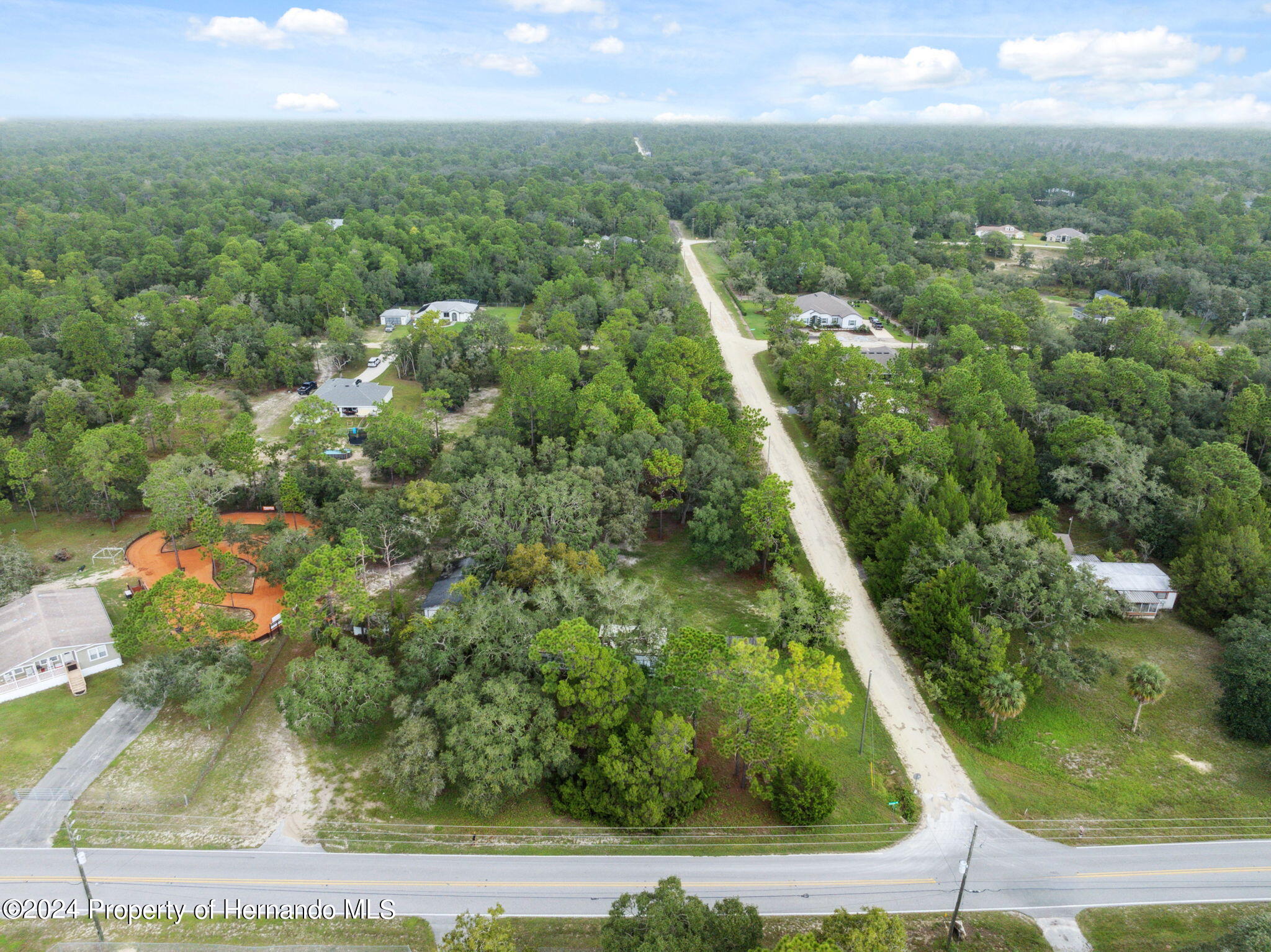 11017 Knuckey Road Weeki Wachee, FL 34614 - Photo 2 of 39 an aerial view of residential houses with outdoor space and trees