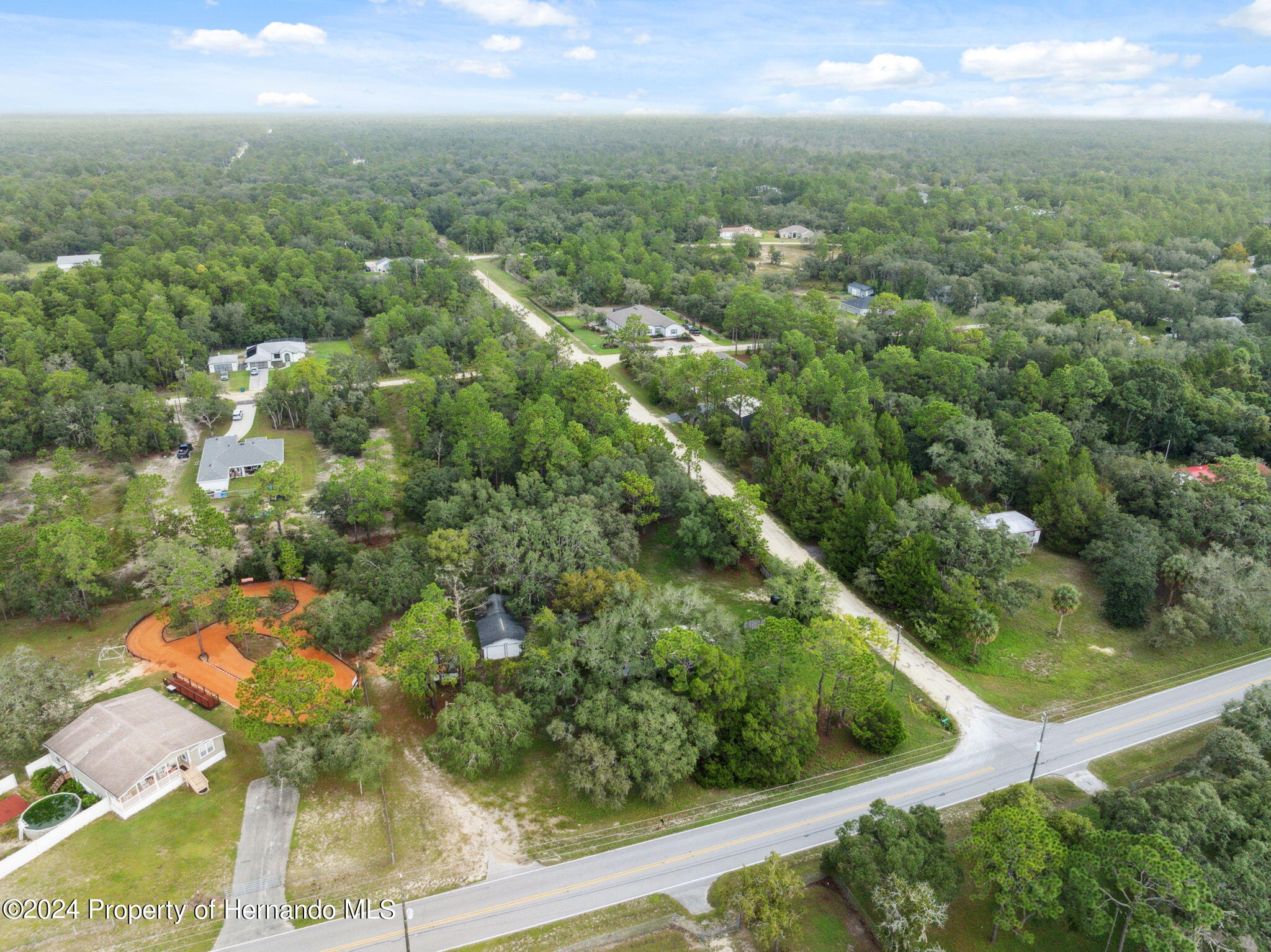 11017 Knuckey Road Weeki Wachee, FL 34614 - Photo 32 of 39 an aerial view of residential houses with outdoor space and trees