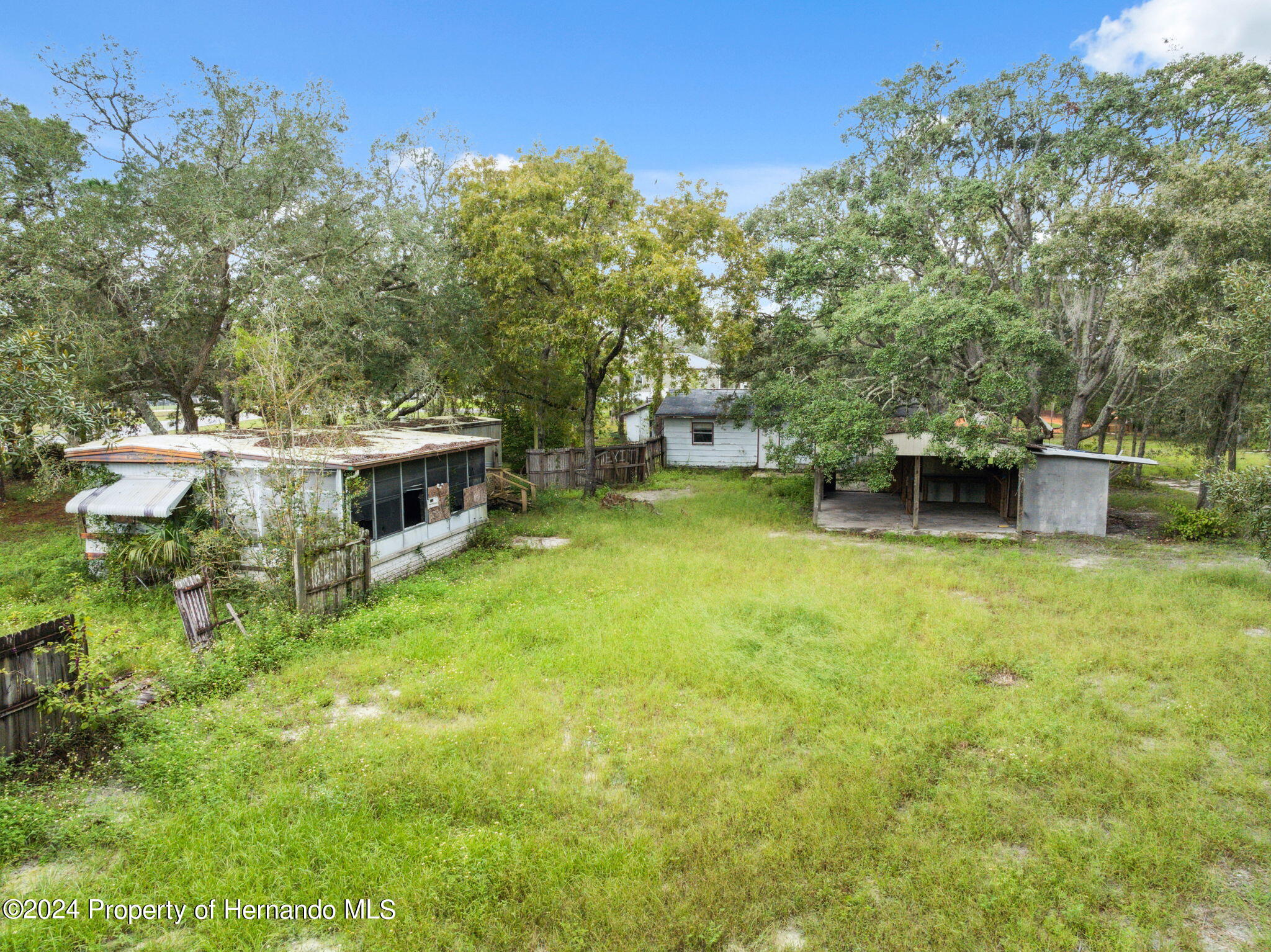 11017 Knuckey Road Weeki Wachee, FL 34614 - Photo 4 of 39 a view of a house with a yard and sitting area