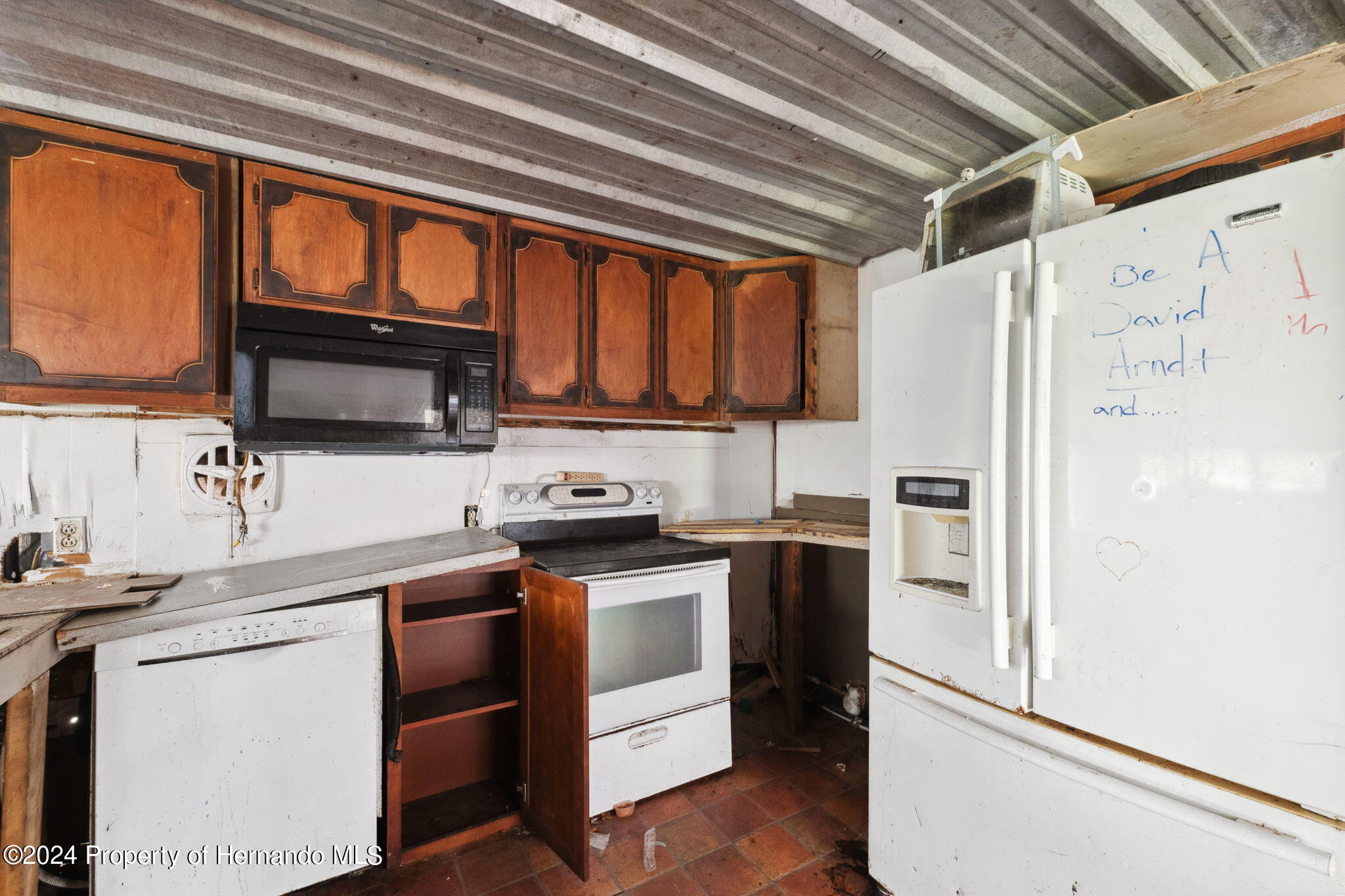 11017 Knuckey Road Weeki Wachee, FL 34614 - Photo 10 of 39 a kitchen with stainless steel appliances granite countertop a refrigerator and a stove top oven