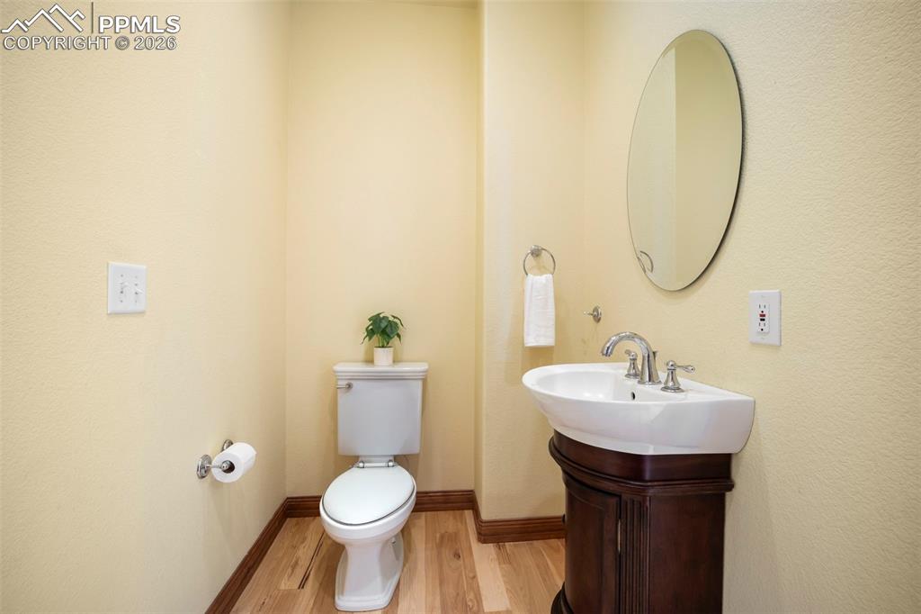 18525 Glenthorne Lane Monument, CO 80132 - Photo 18 of 49 a bathroom with a toilet sink and mirror