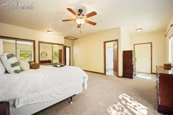 a bedroom with a large bed couch and a window