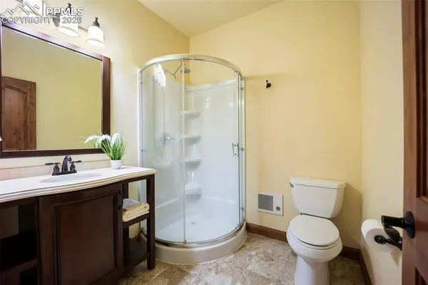 a bathroom with a granite countertop toilet sink and shower