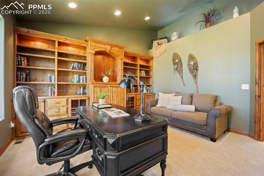 18525 Glenthorne Lane Monument, CO 80132 - Photo 25 of 49 a living room with furniture and a flat screen tv
