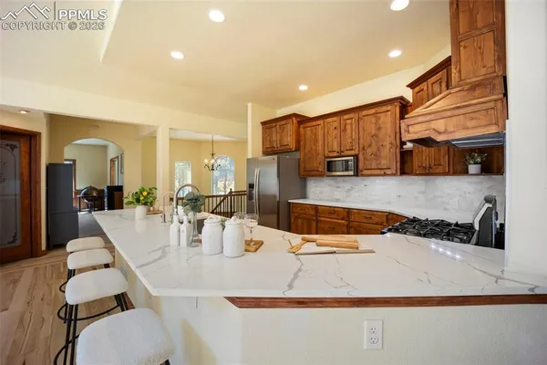 a kitchen with a table chairs and a refrigerator
