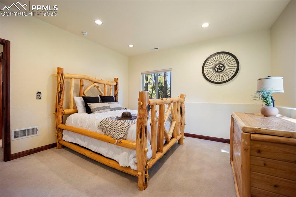 18525 Glenthorne Lane Monument, CO 80132 - Photo 36 of 49 a bed room with a bed and a table