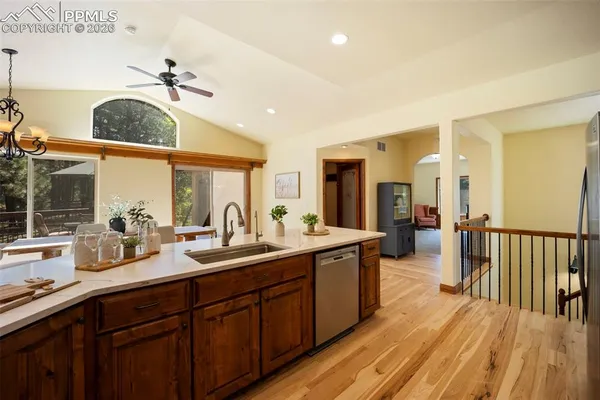 a very nice looking room with a large window and wooden floors