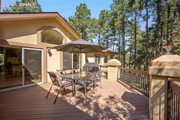 a view of backyard with outdoor seating and wooden floor