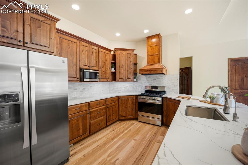 18525 Glenthorne Lane Monument, CO 80132 - Photo 5 of 49 a kitchen with stainless steel appliances granite countertop a refrigerator sink and stove