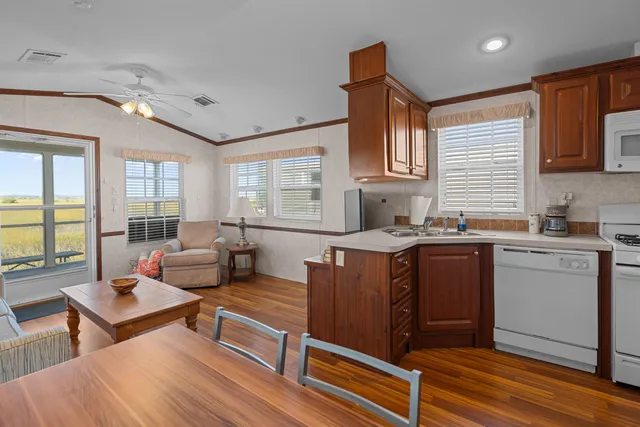 a open kitchen with stainless steel appliances granite countertop a stove a sink dishwasher and a microwave oven with cabinets