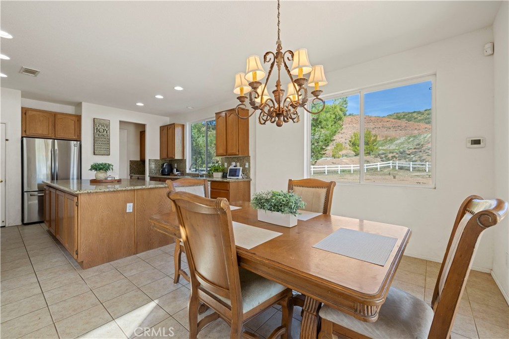 34250 McEnnery Canyon Road Acton, CA 93510 - Photo 13 of 63 a dining room filled chandelier and kitchen view