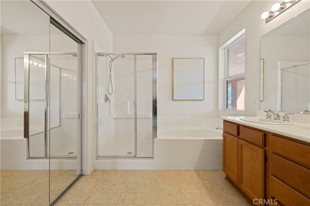 34250 McEnnery Canyon Road Acton, CA 93510 - Photo 24 of 63 a bathroom with a bathtub and a shower