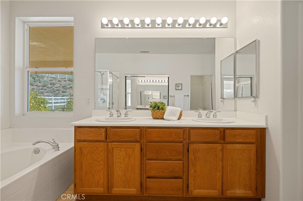 34250 McEnnery Canyon Road Acton, CA 93510 - Photo 25 of 63 a bathroom with a granite countertop sink mirror and bathtub