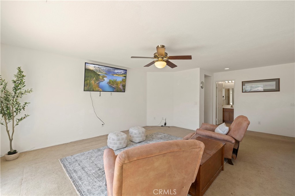 34250 McEnnery Canyon Road Acton, CA 93510 - Photo 27 of 63 a bedroom with a bed and wooden floor
