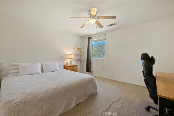a bedroom with a bed and a table