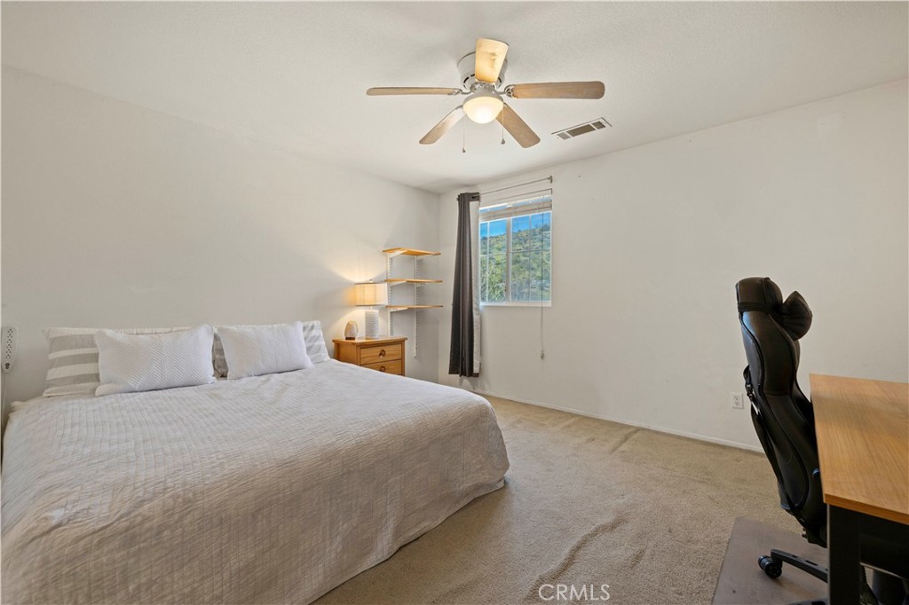 34250 McEnnery Canyon Road Acton, CA 93510 - Photo 35 of 63 a bedroom with a bed and a ceiling fan