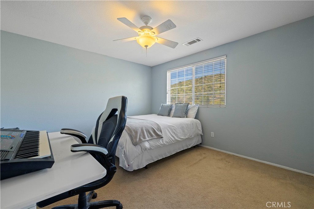 34250 McEnnery Canyon Road Acton, CA 93510 - Photo 41 of 63 a bedroom with a bed and a desk