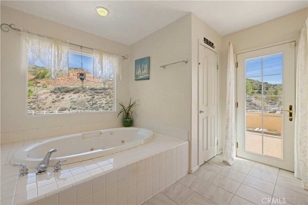 34250 McEnnery Canyon Road Acton, CA 93510 - Photo 50 of 63 a bathroom with a bathtub and a shower