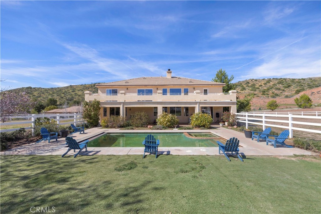 34250 McEnnery Canyon Road Acton, CA 93510 - Photo 56 of 63 a view of a swimming pool with a patio and a yard