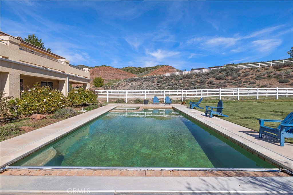 34250 McEnnery Canyon Road Acton, CA 93510 - Photo 57 of 63 a view of a swimming pool with a patio